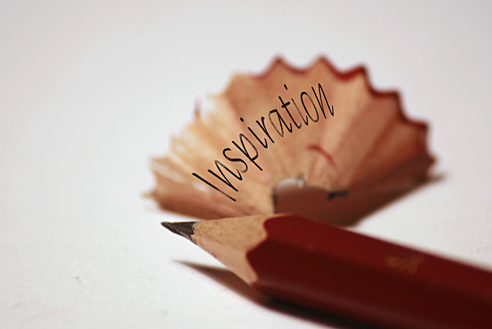 image shows a pencil for writing entrance exams writing papers and the word inspiration